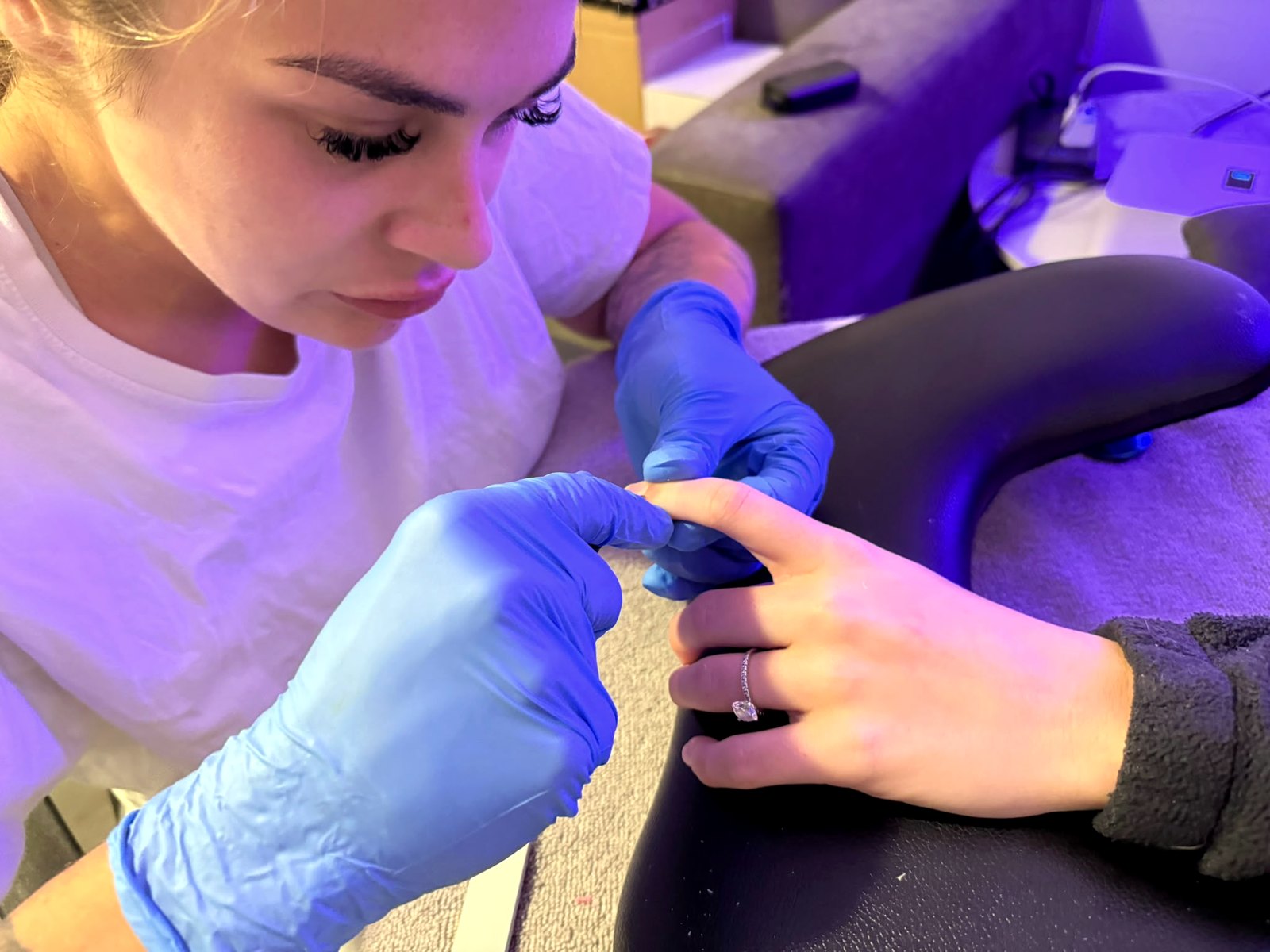 Melisha shaping a client's nails in the studio